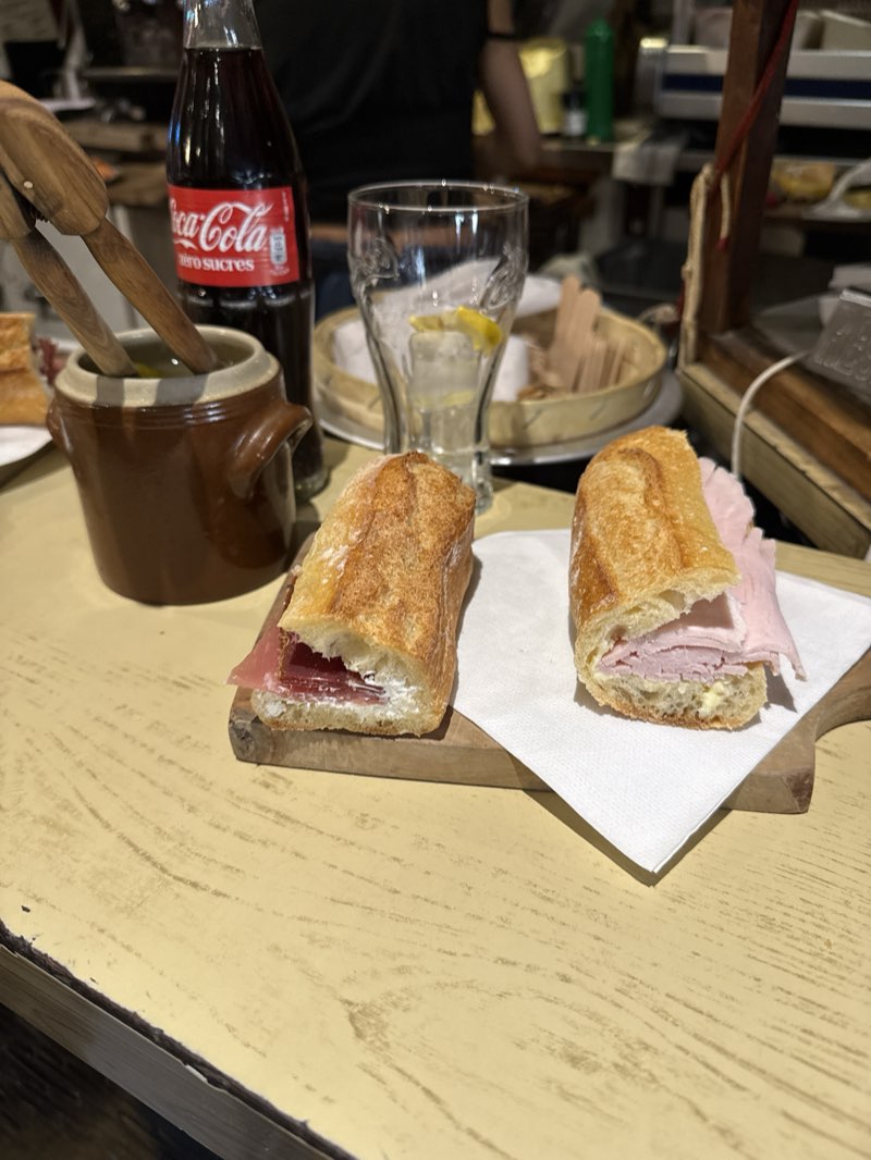 Two baguette sandwiches on a wooden board at Le Petit Vendôme