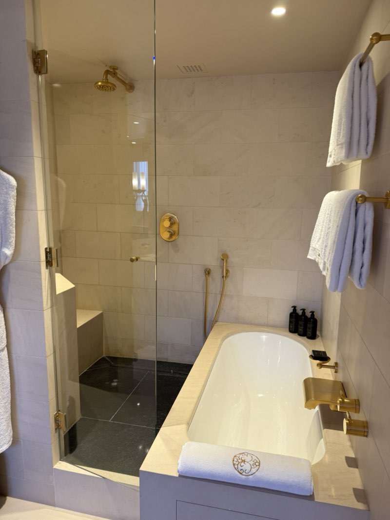 Marble bathroom with a bathtub and gold fixtures at the Park Hyatt Paris-Vendôme