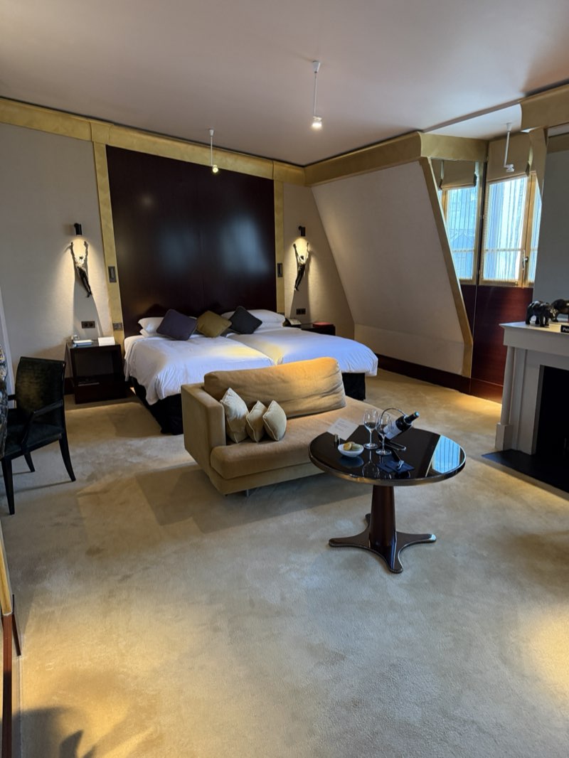 Hotel room at the Park Hyatt Paris-Vendôme with a bed, a sofa, and a small round table